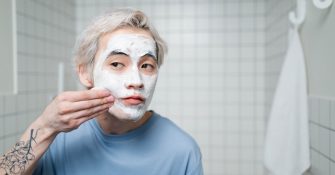 picture of a man applying a skincare product on his face
