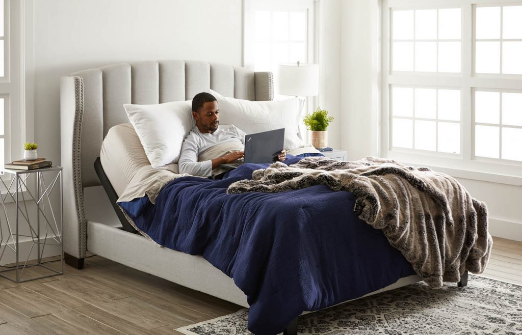 man laying in a adjustable bed