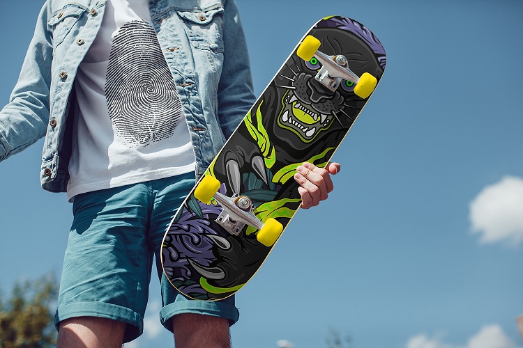 man holding complete skateboard 