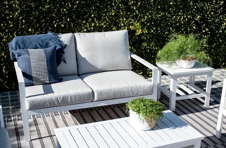 white outdoor furniture with grey pillows