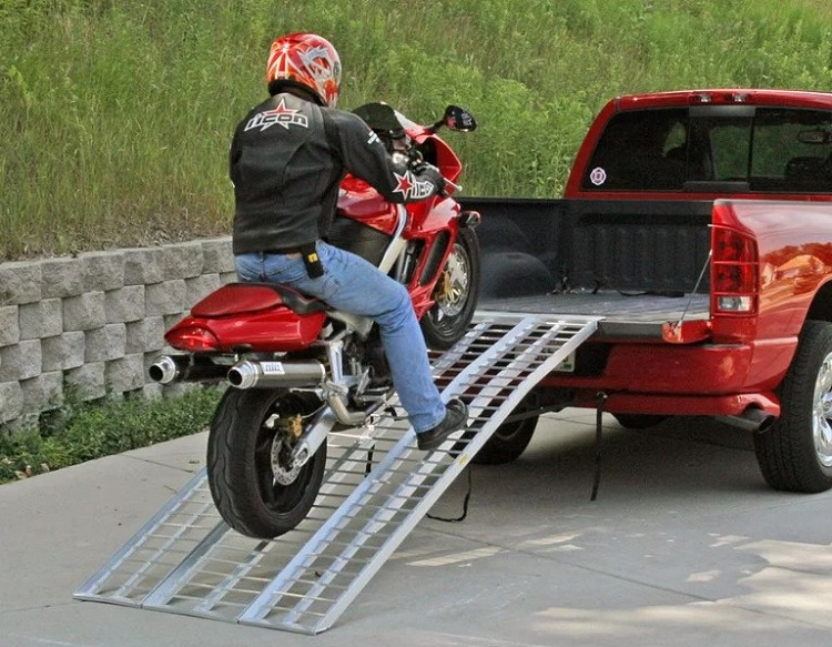 Man loading a bike on ramp while sitting on it