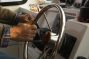 man using hydraulic steering wheel on the boat