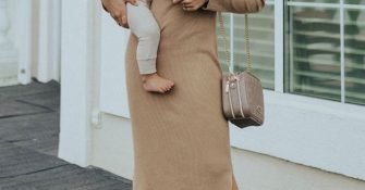 woman holding her baby and wearing breastfeeding dress