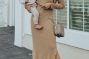 woman holding her baby and wearing breastfeeding dress
