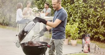 man making grill on the barbeque smoker for the family