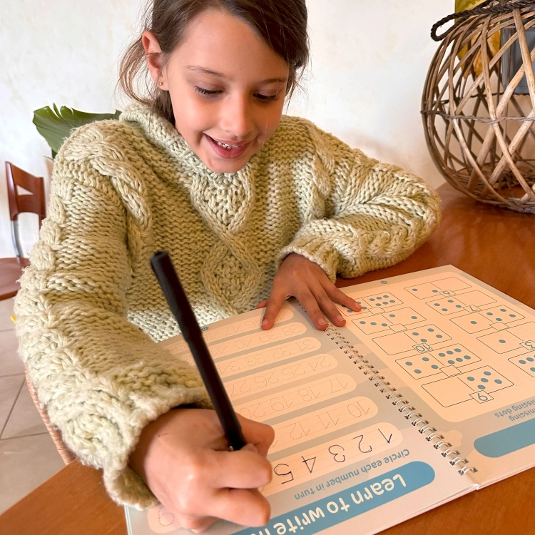 a girl writing in Targeting Handwriting NSW book