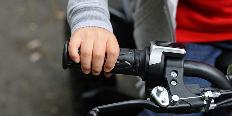 close up of kid's hand on an e-bike