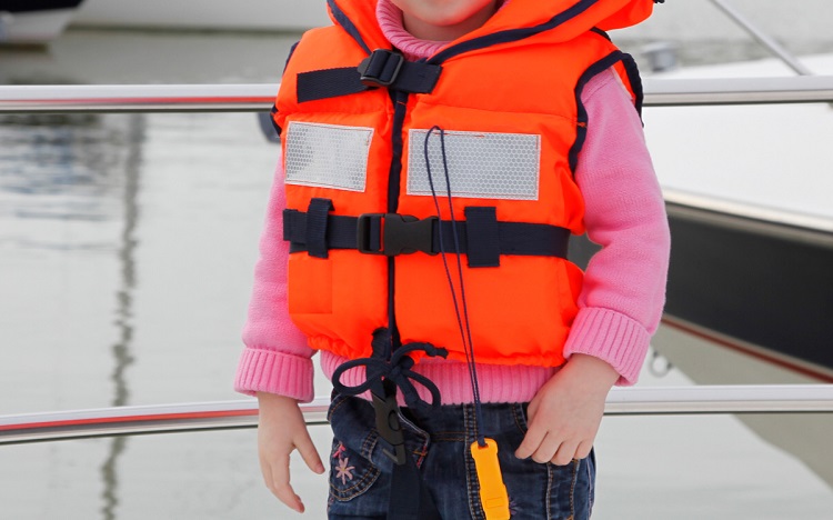 little kid wearing life jacket