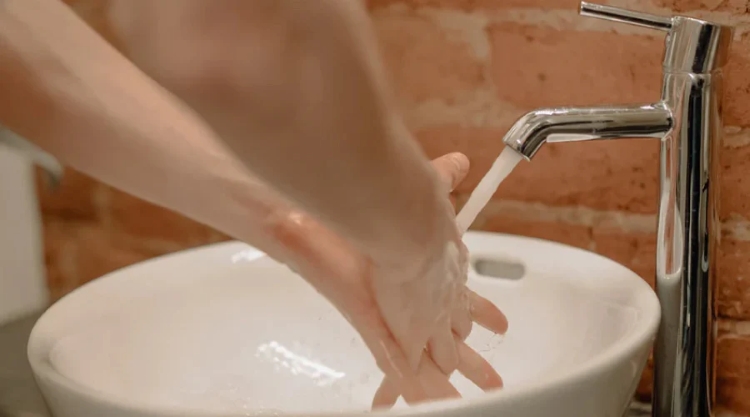 person using a bathroom mixer tap